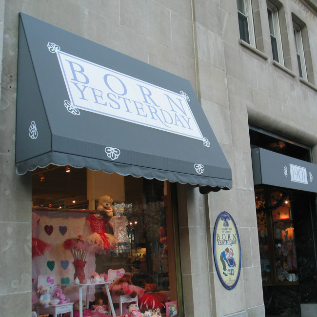 storefront awnings printed with logos, patterns, and the address